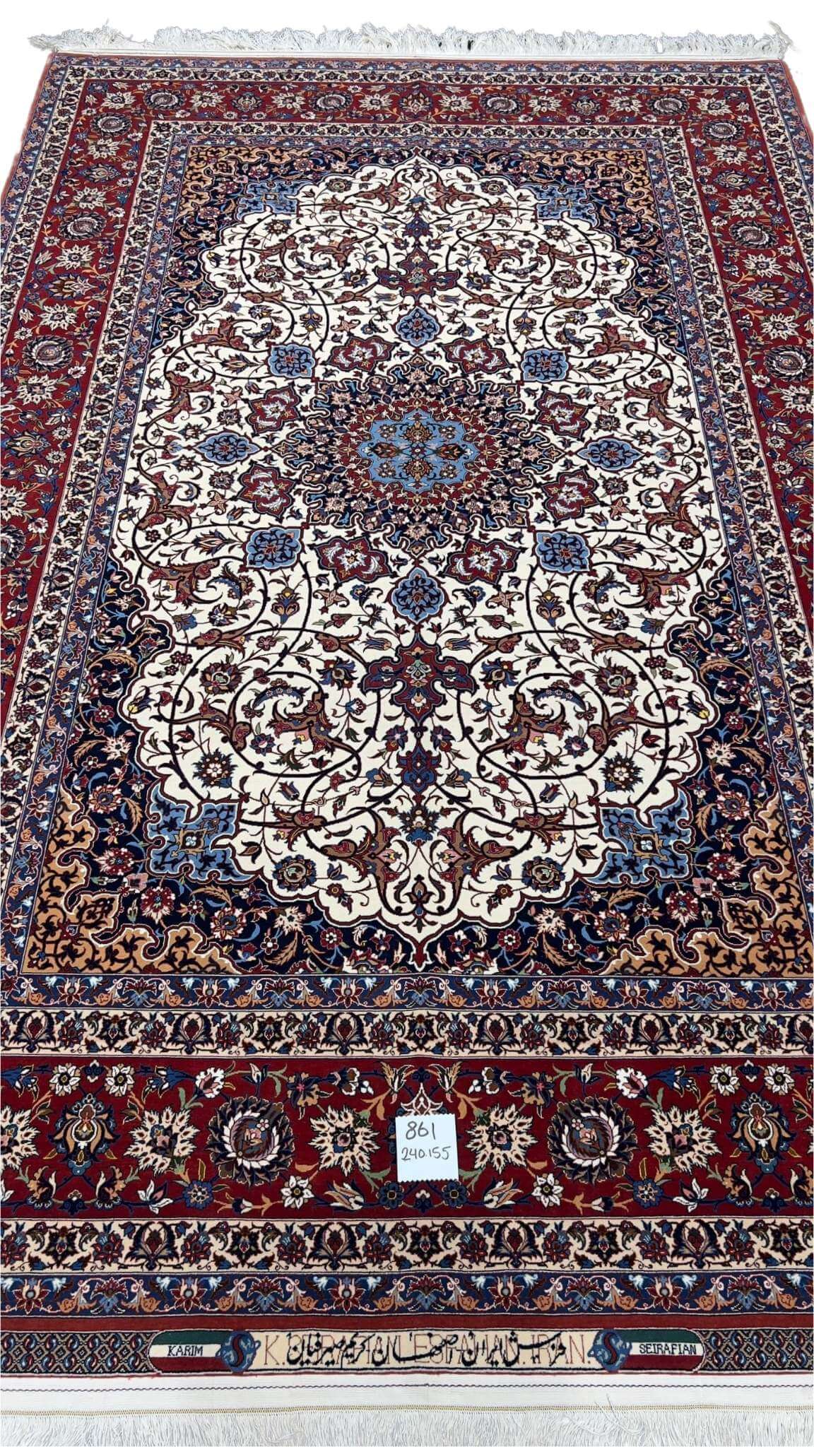 An elegant hand-knotted 5 x 7 red and beige Seirafian Persian rug from Isfahan, crafted by Grand Master Karim Seirafian with intricate patterns and rich detailing.